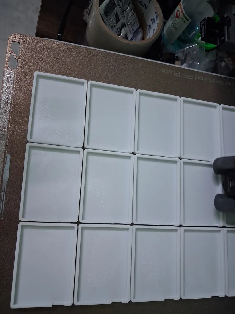 Tray of white 3D printed parts after a production run
