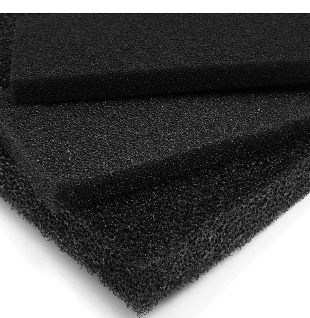 Black reticulated polyurethane foam sheets stacked, showing a finer pore grade above a coarser open-cell grade